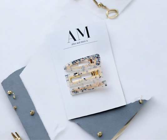 Decorative hair clips on a magazine with a minimal background