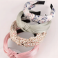 Set of colorful headbands on a light pink background